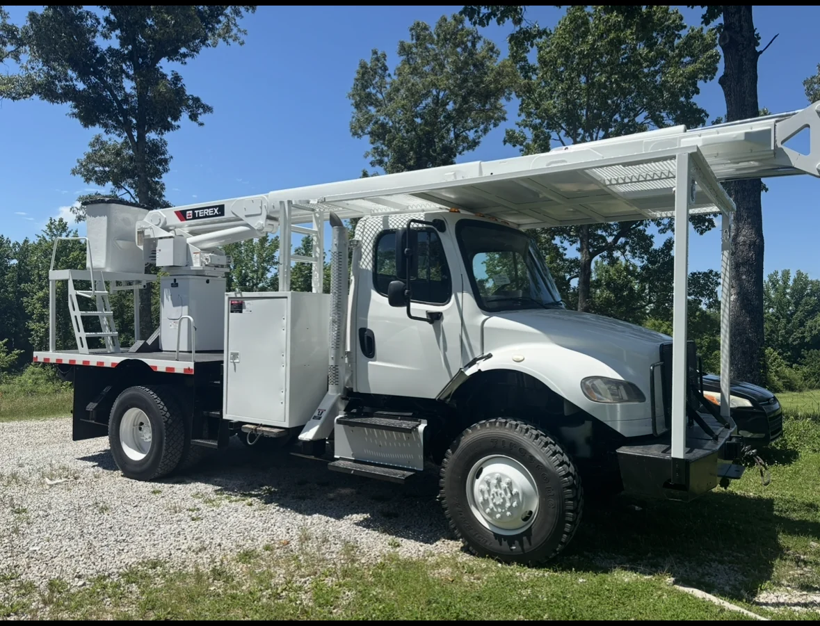 Tree service truck beside a property